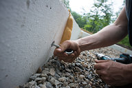 Tyler Affixing Eyelets to Concrete Form